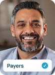 Smiling businessman sitting on couch looking directly at camera