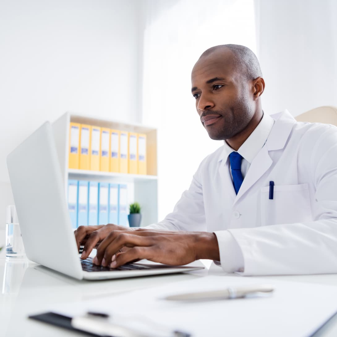 professional pharmacist specializing in medication management working working at computer 