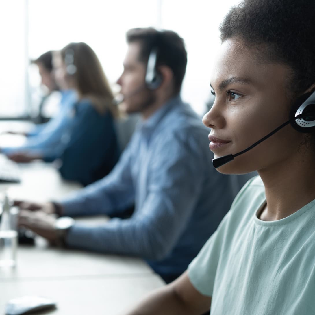 Call center service operator with headset managing compliance programs for high-risk patients.